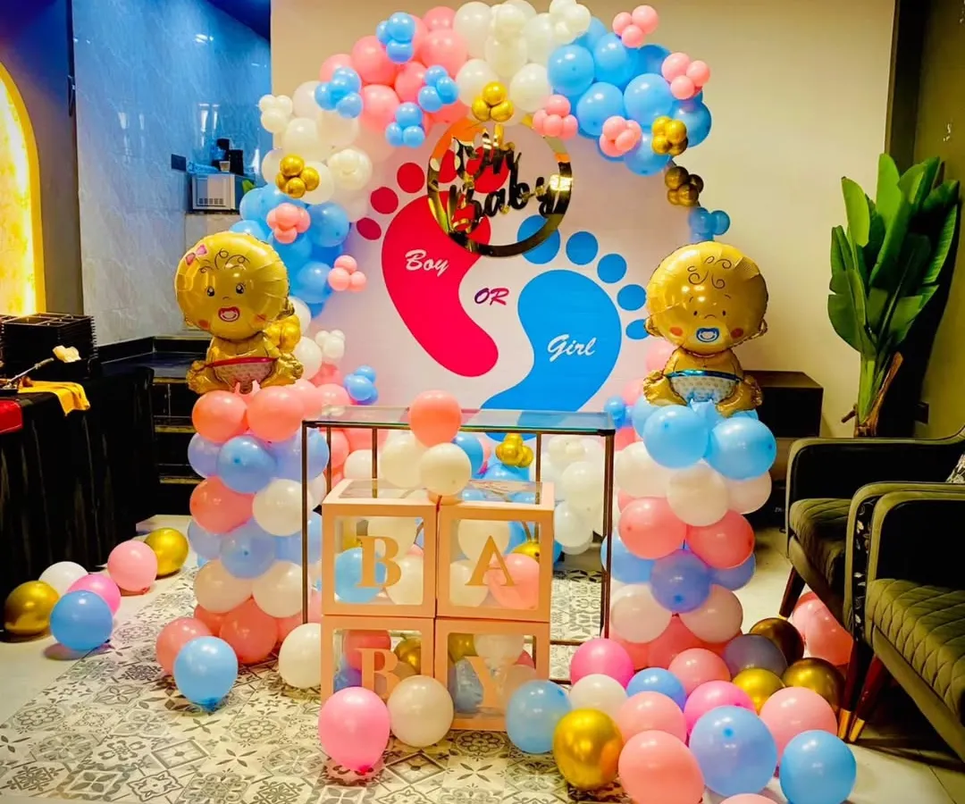 Is it a boy or a girl? I create fun and exciting gender reveal party decorations like this one. This setup includes a custom backdrop, "Boy or Girl" signage, and perfectly coordinated pink and blue balloons with cute foil baby balloons.
