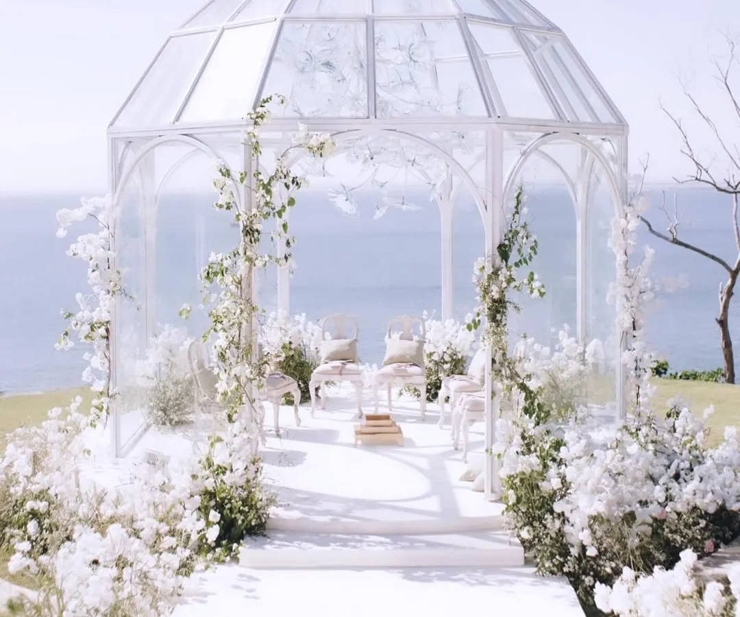 For this destination wedding in Bali, I envisioned a mandap that felt both ethereal and one with nature. A modern glasshouse perched on a cliff, overlooking the ocean, created a breathtaking backdrop for a truly romantic garden soiree.