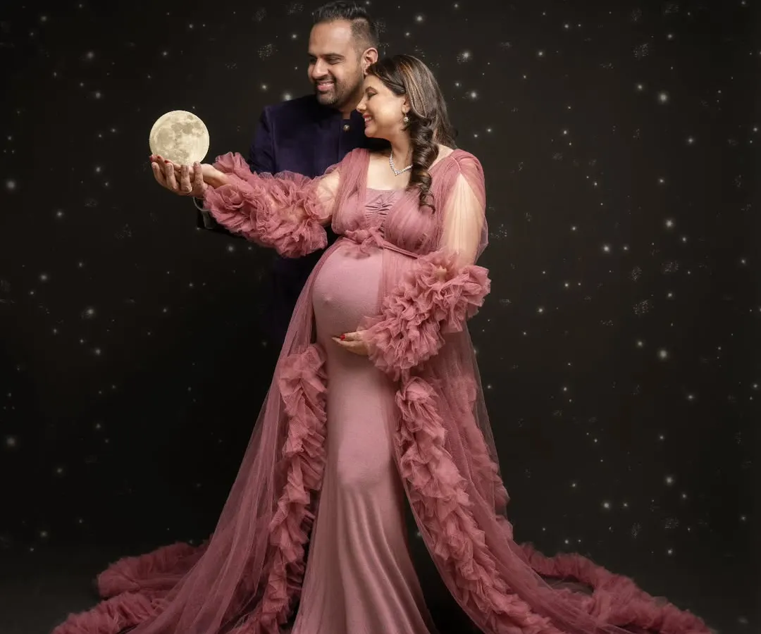 I believe in creating magic. For this celestial-themed maternity portrait, we brought the moon down from the stars to celebrate the universe of love this couple is creating. It’s a blend of fantasy and the very real joy of expecting.