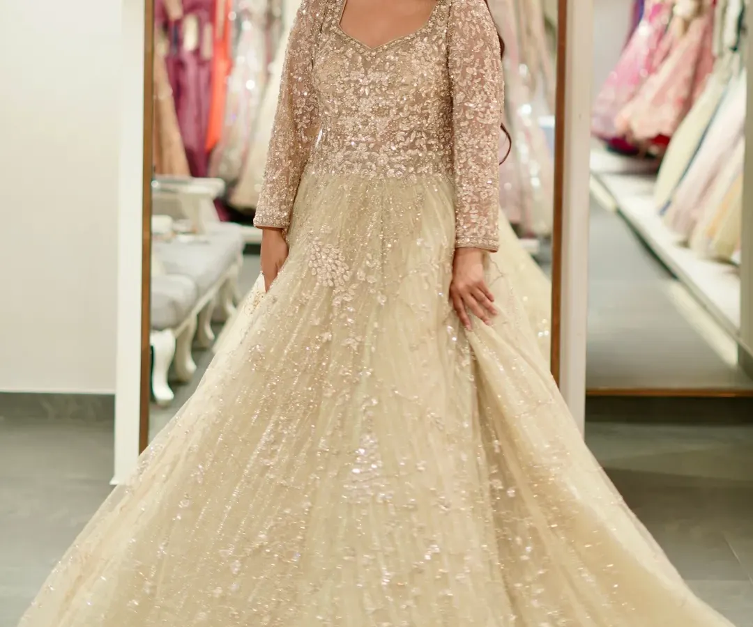 For your reception or engagement, imagine walking in wearing this. This beige gown is pure fairytale, covered in sparkle that catches the light with every move you make. It’s designed for that unforgettable twirl on the dance floor.