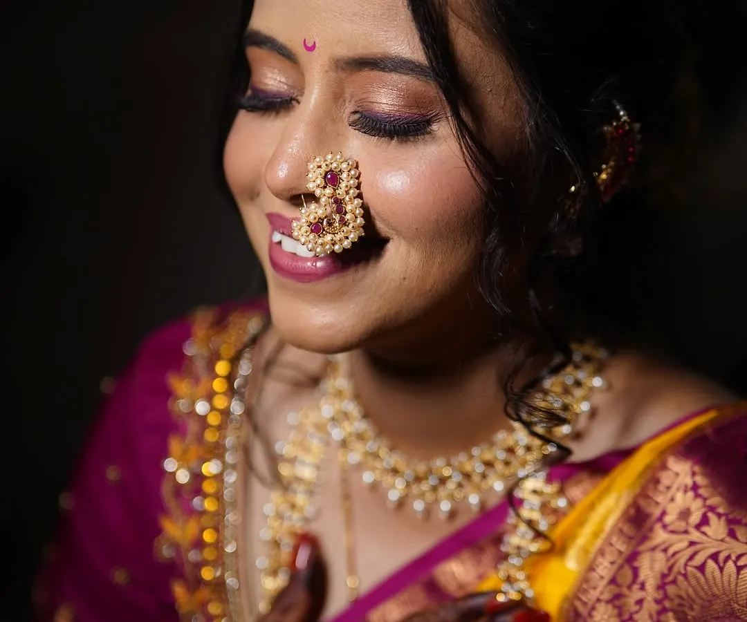 A close up on the details that matter. For this bride, I focused on a soft glam eye with a hint of shimmer and a perfectly blended skin finish that looks and feels natural. The look is completed with a traditional pearl nath, embodying the grace of a classic Marathi bride.