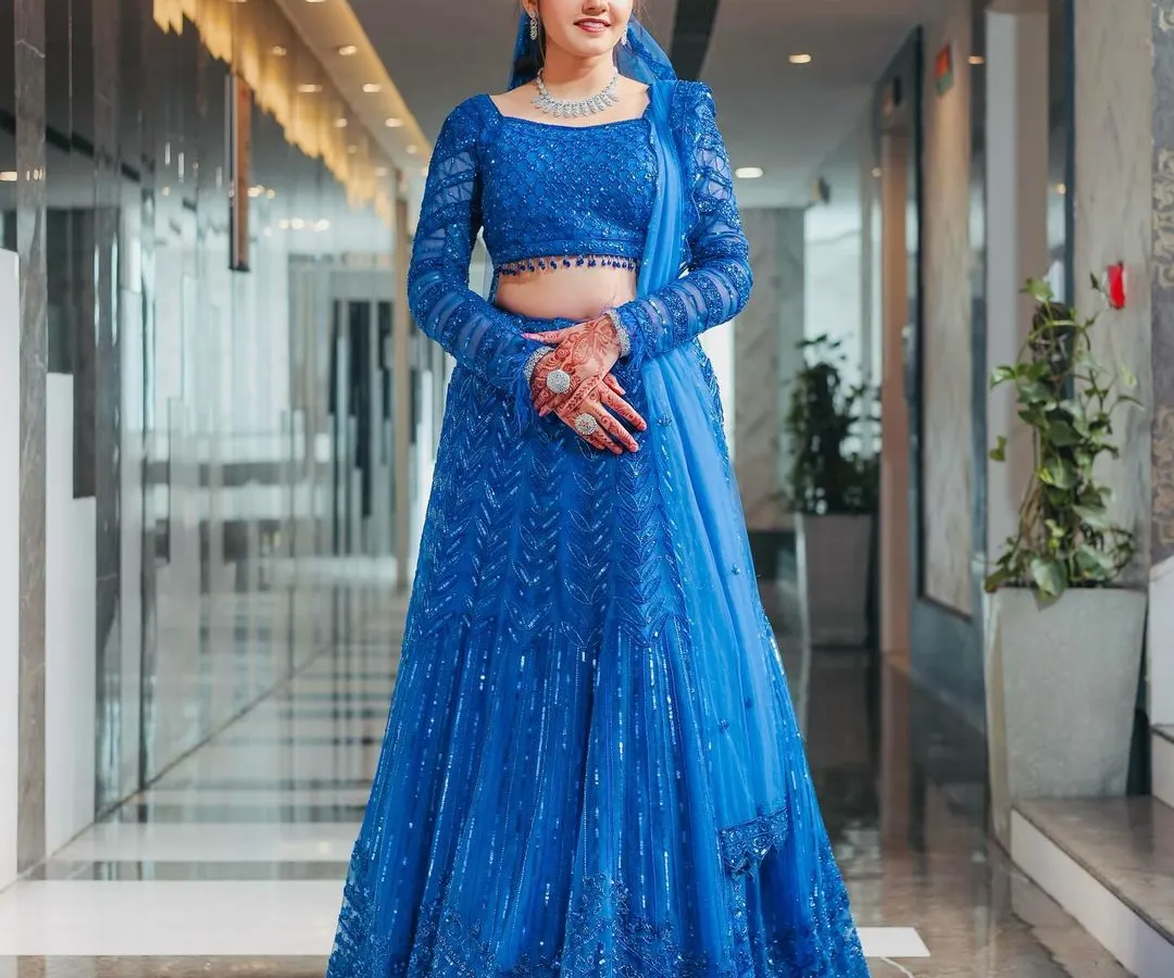 Seeing my client shine in this custom royal blue lehenga is what it's all about. This piece features full-sleeve detailing and head-to-toe sequin work, making it a perfect, modern choice for a sangeet or reception.