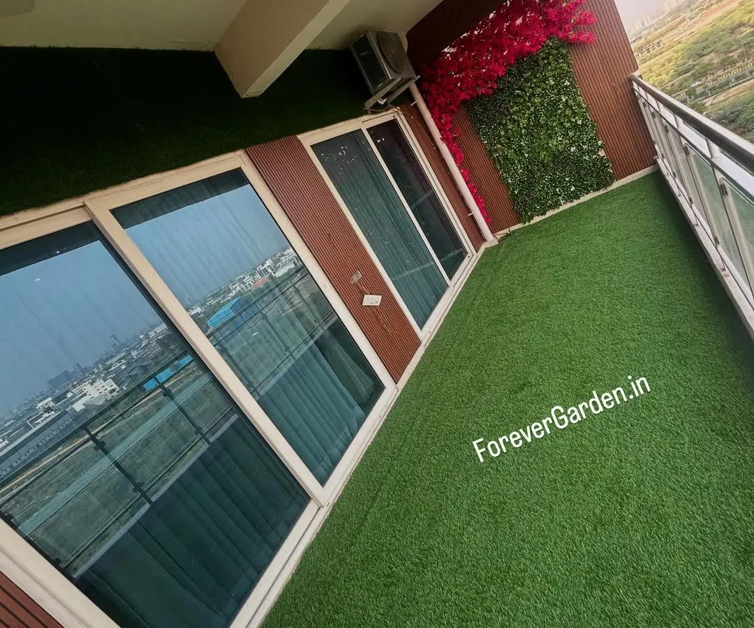 I can turn any urban balcony into a green oasis. This high-angle shot shows a complete transformation with wall-to-wall artificial turf, providing a maintenance-free lawn with a stunning city view.