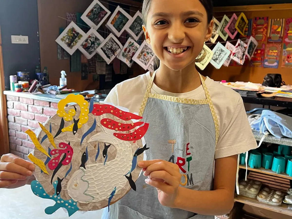 Look at that smile. This is the best part of my job, seeing a young artist proudly show off a piece they created with their own hands. This collagraph project allowed her to play with textures and shapes to make something truly unique.