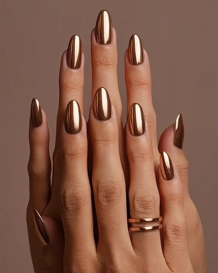 They call me the 'queen of bling' for a reason. This full set of almond-shaped chrome nails in a brilliant liquid gold finish is the ultimate statement in luxury. It's a bold, high-impact look that I love creating for clients who aren't afraid to stand out.