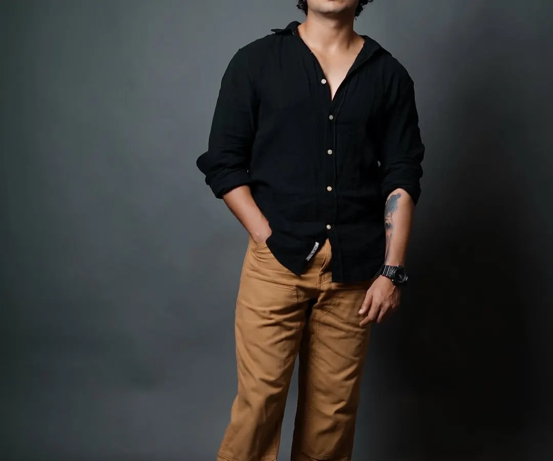 A classic male model portfolio shot. The focus here is on a clean, direct look with simple styling, allowing the model's features and confident expression to take center stage. We use precise studio lighting to create this sharp, professional result.