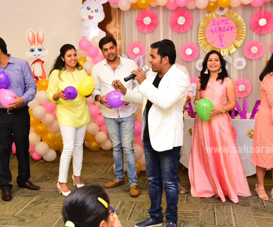 Leading a balloon game for the adults at a 'Some Bunny is One' first birthday party in Bangalore. My goal is to make sure everyone feels included and has a chance to participate.