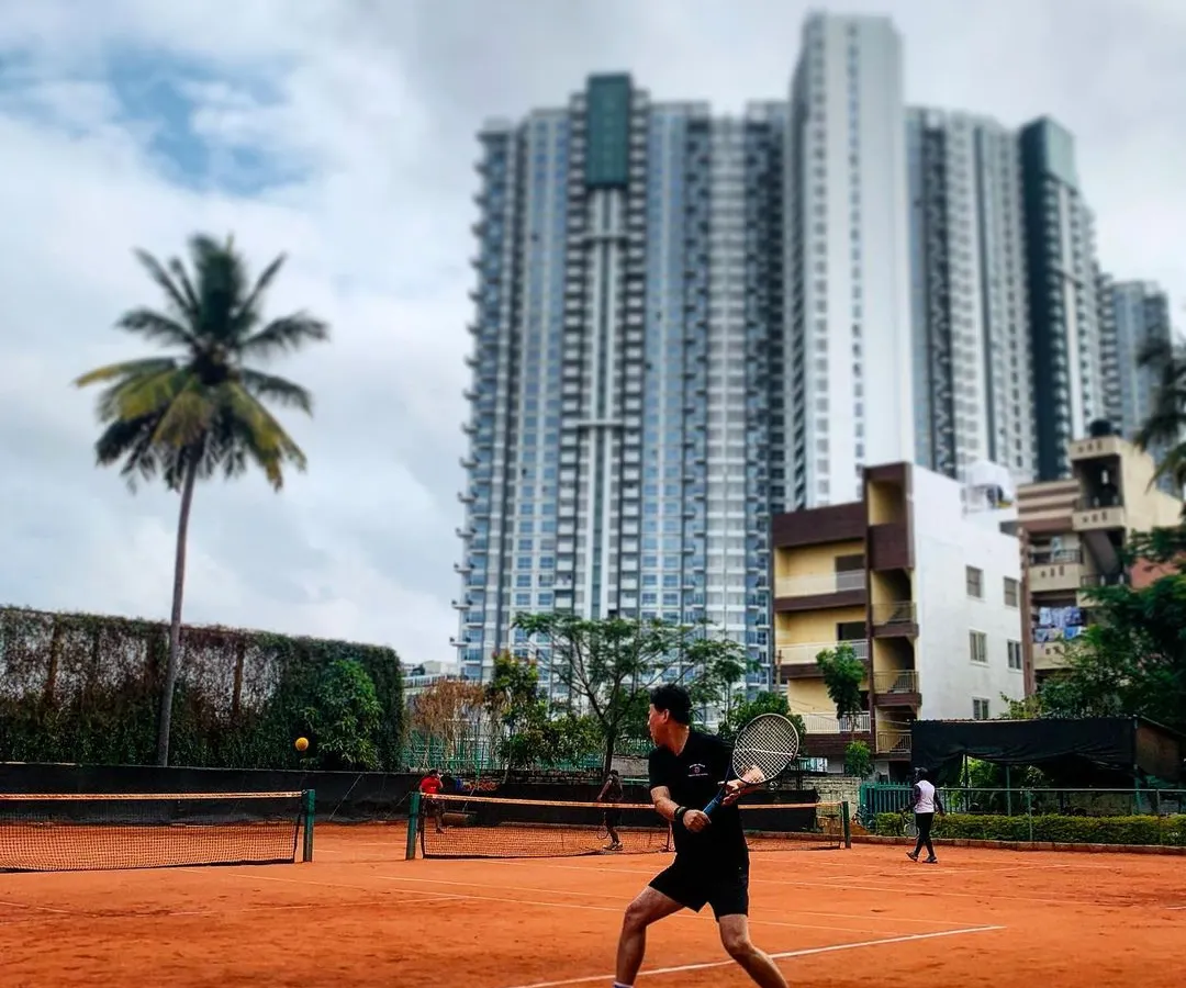 Here you can see a player locked in during a rally, with the city skyline in the background. I built this place to be an urban oasis where you can play hard and leave the city noise behind.