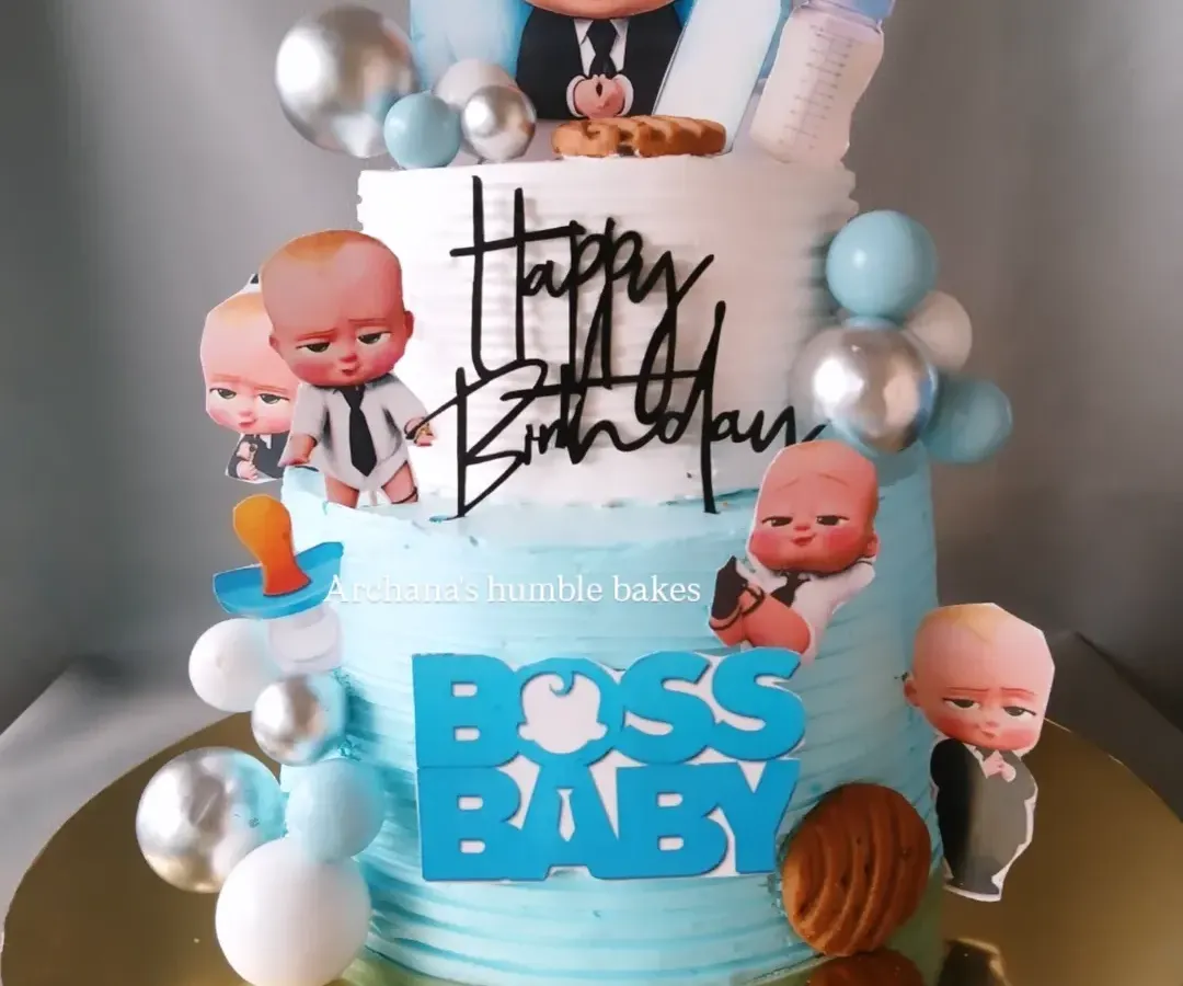 For little Nyhaan's first birthday, we created this fun two-tiered Boss Baby cake. It's one of my most requested cartoon themes, and I love bringing this character to life with lots of fun details, all completely eggless.