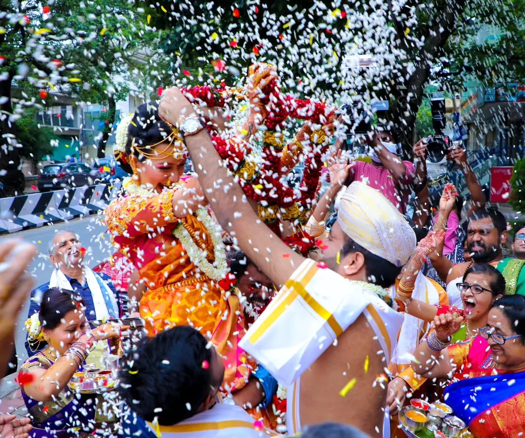 There's nothing like the pure joy of a wedding celebration. I love capturing these candid moments, like this traditional flower shower during a Muhurtam ceremony. It’s all about real emotions and vibrant colors.