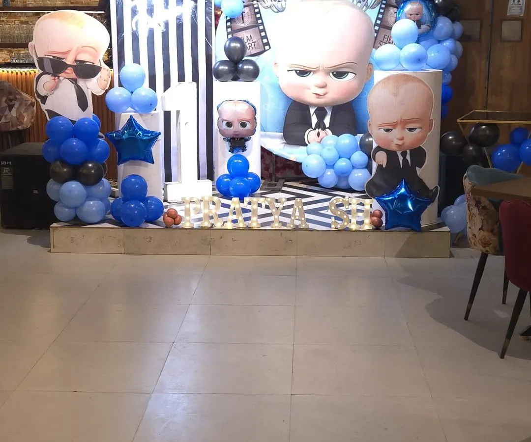 This is how I bring popular themes to life. Here's a look at a 'Boss Baby' first birthday party setup at my Noida Sector 63 hall, featuring a custom backdrop, character cutouts, and a blue and black balloon arrangement to create the perfect photo zone.
