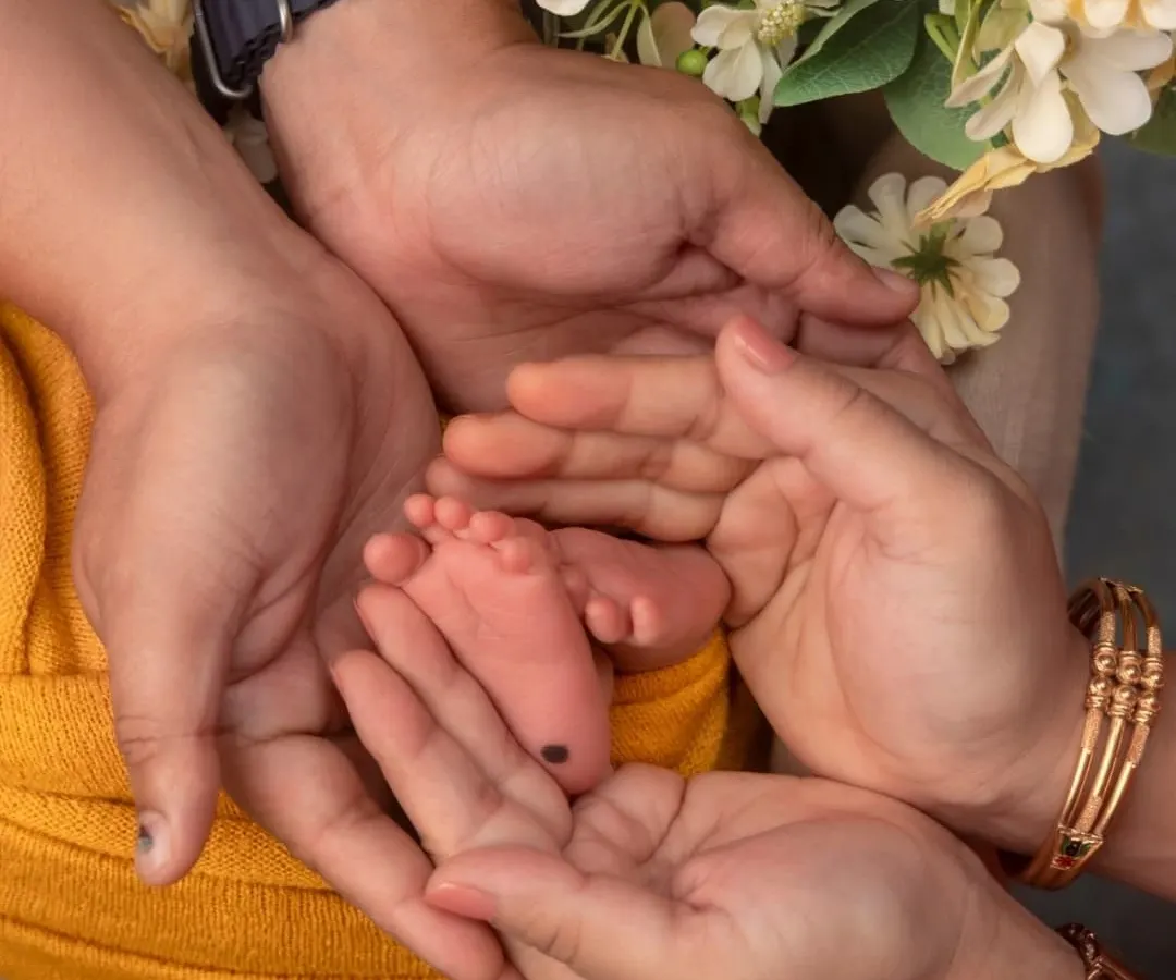 The world seems so big, and they are so wonderfully small. I focus on these tiny details, like parents' hands cradling their baby's feet, to create cherished images that celebrate this fleeting moment.