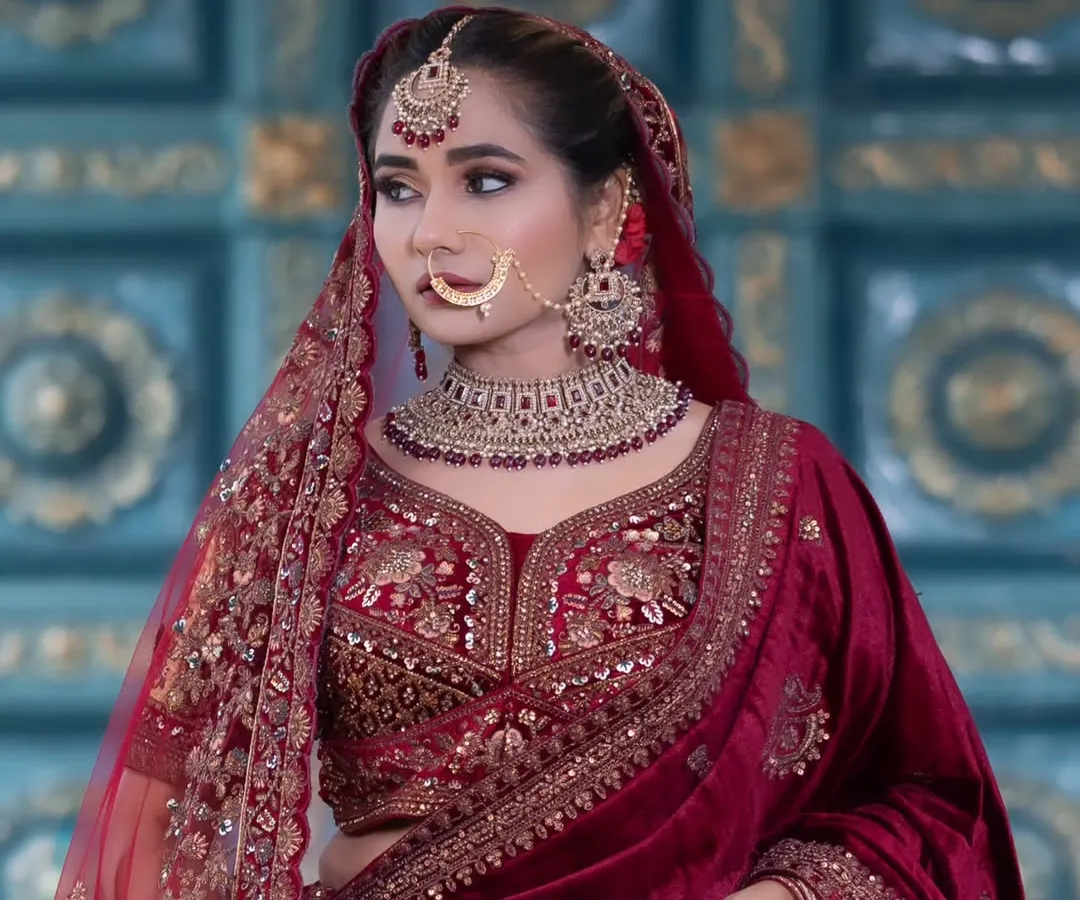 For my North Indian brides, I have a wide collection of Kundan and Jadau jewellery. This bridal set features a heavy choker with deep red stones, a matching maang tikka, and a traditional nath, perfect for a lehenga.