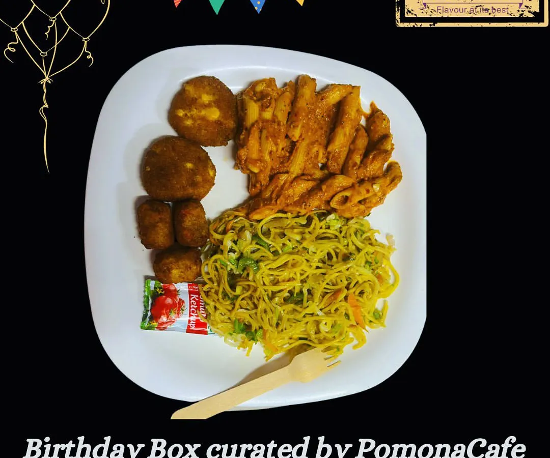 A sample birthday party meal, plated to show a delicious combination of hakka noodles, penne pasta, and vegetable cutlets. My birthday boxes are designed to be a complete, satisfying meal for guests of all ages.