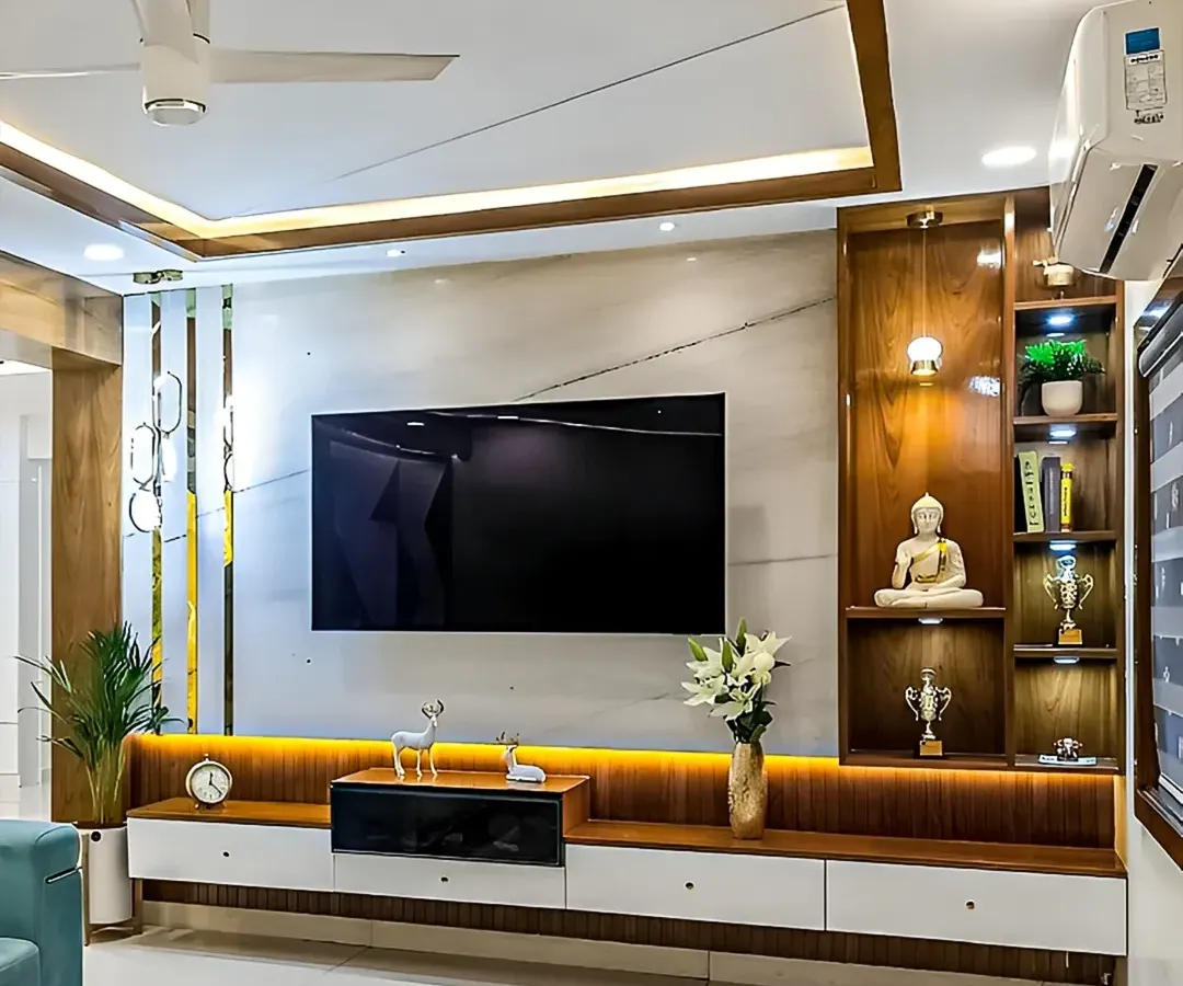 This living room showcases a full-wall media unit we designed. It features a mix of warm wood and white laminate, with integrated backlighting to create a cozy ambiance, and combines open shelving for display with closed cabinets for clutter-free storage.