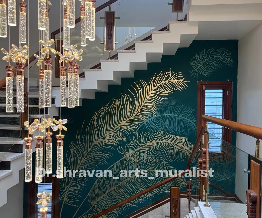 This double-height staircase wall was transformed with delicate, hand-laid gold foil feathers over a deep teal background. The way the metallic finish catches the light as you walk by creates a dynamic and luxurious experience, turning a simple wall into a statement piece.