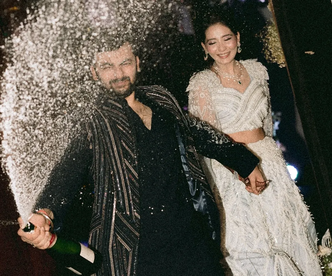 This is the energy we live for. A sangeet night isn't just about dance, it's about pure, unadulterated joy. Capturing this exact moment of a champagne pop, with the couple's ecstatic expressions, shows our ability to freeze high-energy moments and turn them into timeless memories of celebration.