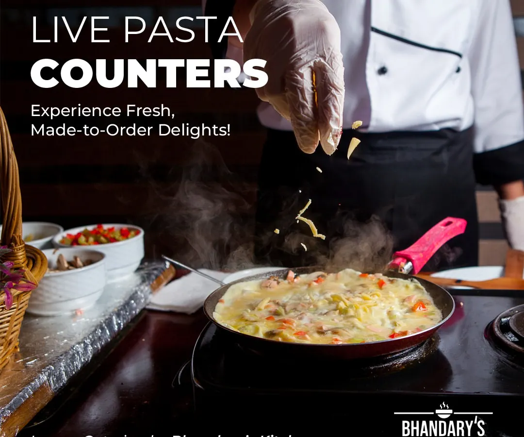 I bring the restaurant experience to you with interactive live counters. Here, one of my chefs prepares fresh pasta to order, providing both entertainment and a made-for-you meal that elevates any corporate lunch or event.