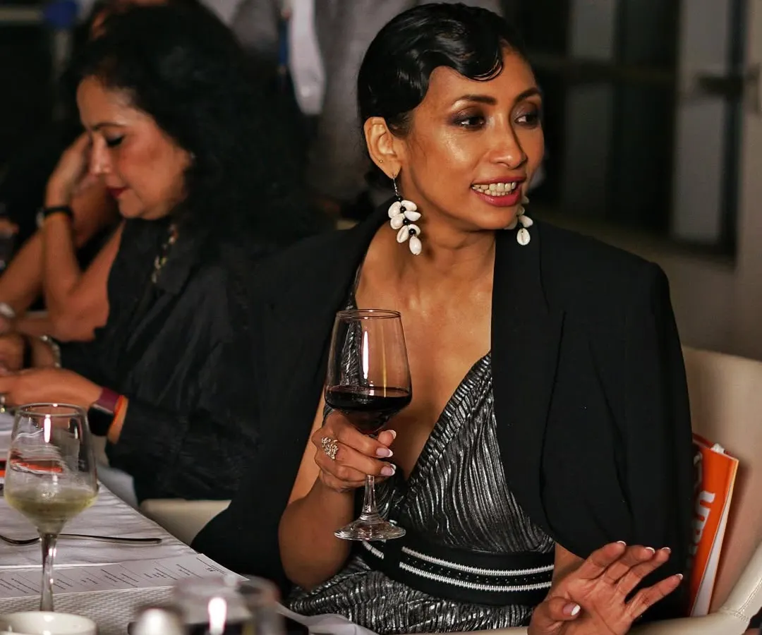 This is a perfect example of an unscripted moment I love to capture. A guest enjoying a conversation over a glass of wine at a dinner party. My event photography focuses on these real, relaxed expressions that truly reflect the atmosphere of your gathering.