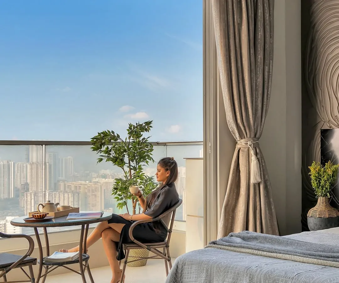 I believe a home should feel like a getaway. This bedroom, opening onto a balcony with a sweeping city view, is styled to create a staycation state of mind. It’s a peaceful escape where you can pause and enjoy the moment.