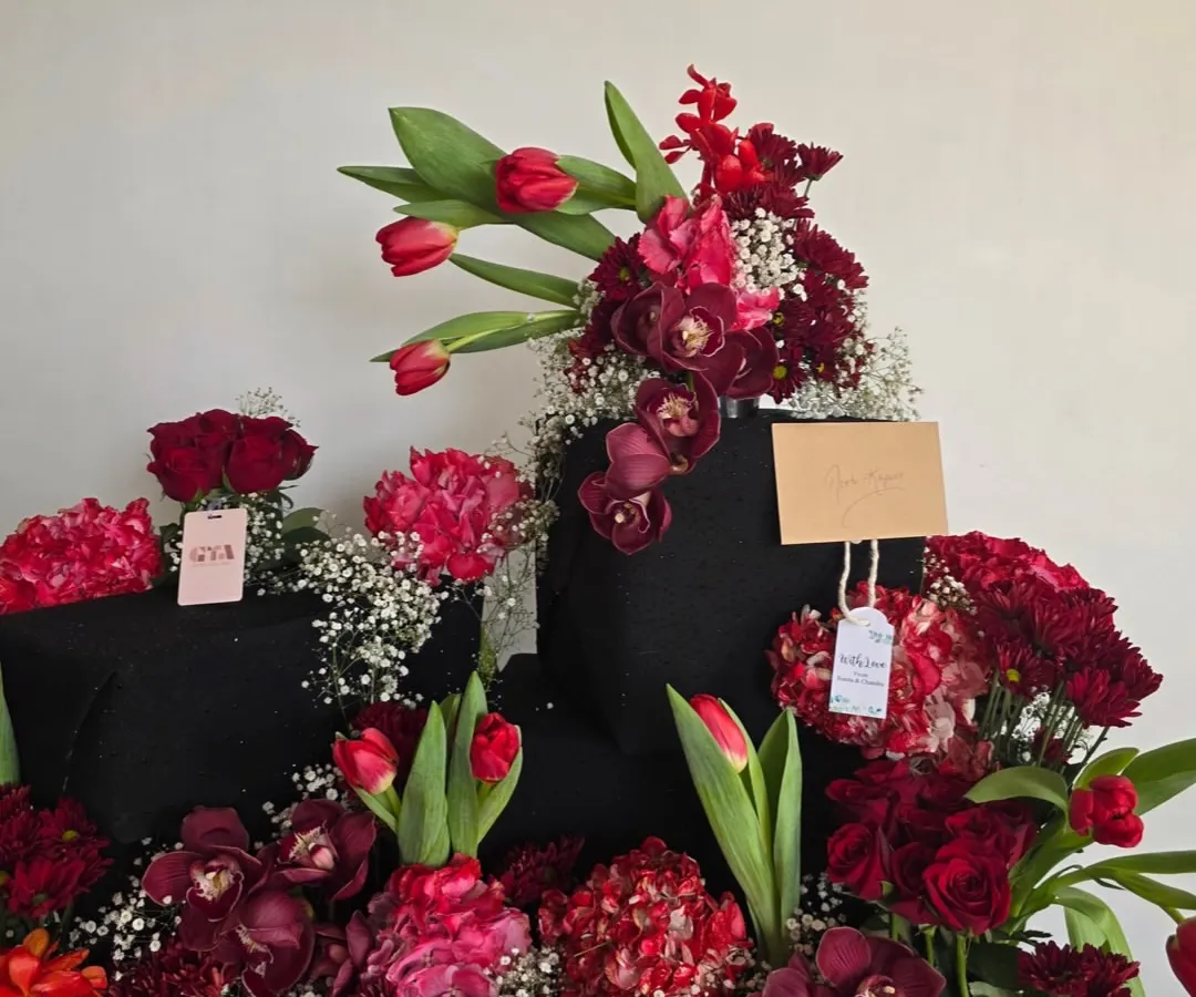 It was an honor to create this dramatic arrangement for the lovely Neetu Singh Kapoor. A cascade of rich red tulips, orchids, and roses creates a powerful statement of love and celebration, perfect for a truly special occasion.