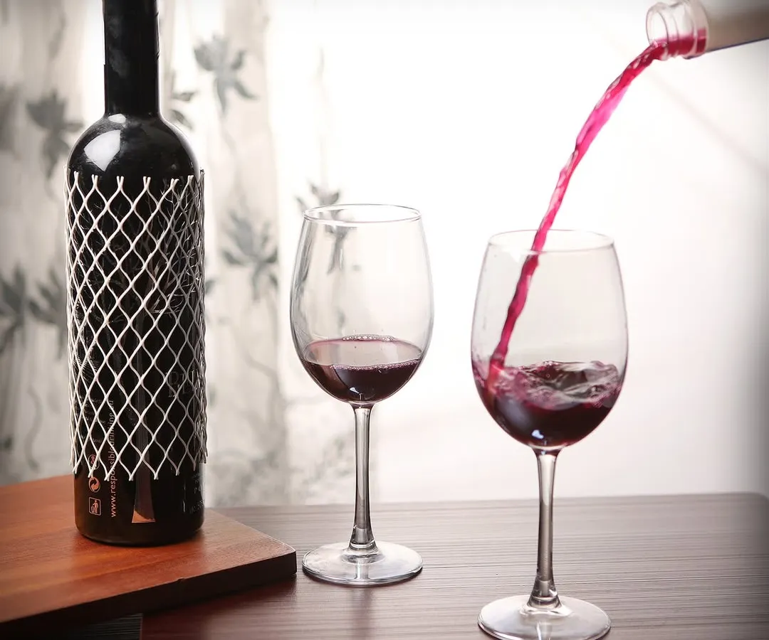 We excel at capturing dynamic action shots that bring beverages to life. This photograph freezes the moment of red wine being poured, highlighting the liquid's color and motion, a technique that adds energy and appeal to product listings and promotional materials.