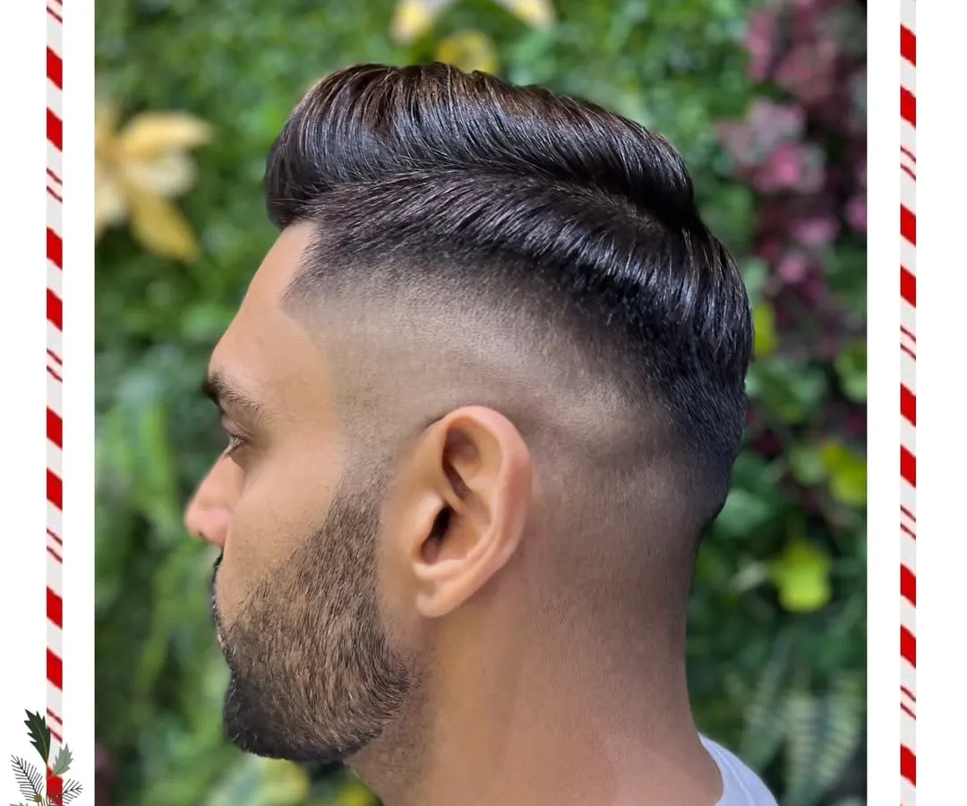 Precision is key in our men's grooming services. Here, we've crafted a sharp skin fade that blends seamlessly into a styled, voluminous top for a clean and modern look.