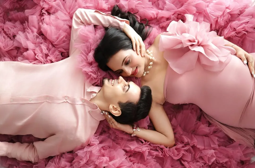 A quiet moment of connection before two become three. This overhead shot, surrounded by a sea of soft pink tulle, is one of my favorite creative poses for capturing romance.