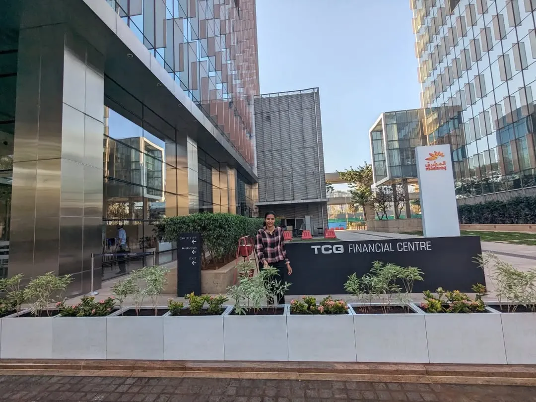 Here is the finished installation at the TCG Financial Centre in BKC, Mumbai. The clean lines of the light-colored, rectangular FRP planters create a modern and welcoming entrance, filled with a mix of Variegated Tagar and Ixora plants that add texture and color.