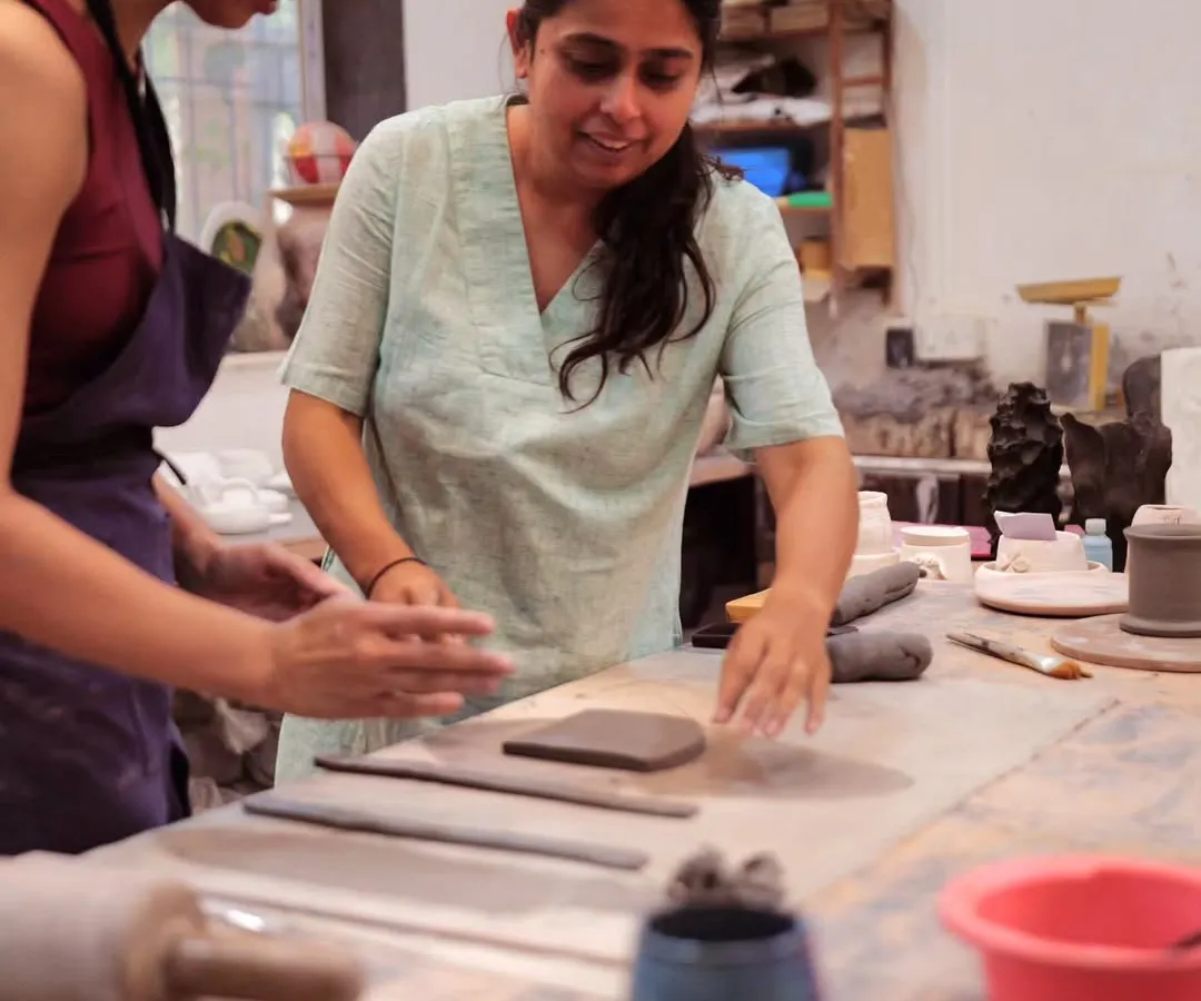I’m Yashashri, and I’m here to guide you on your clay journey. In this photo, I'm helping a student with a hand-building technique, ensuring they feel comfortable and confident as they create.