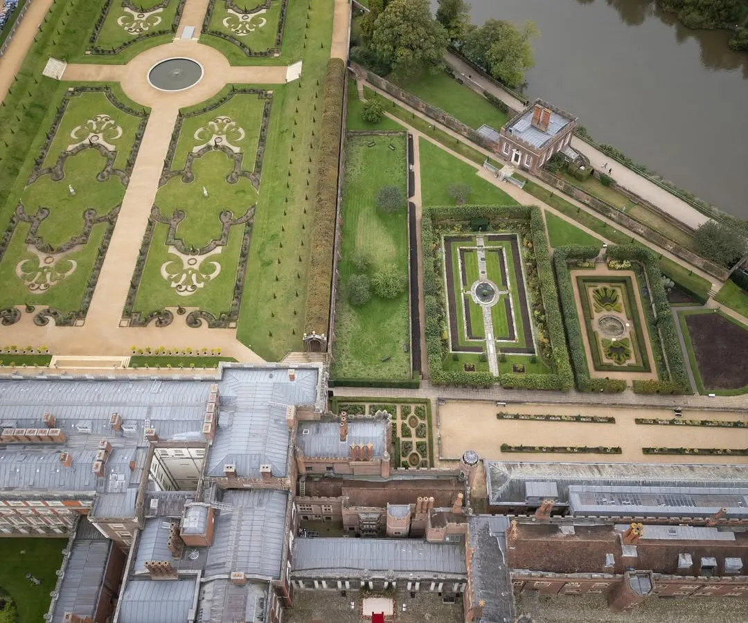An aerial view of the historic Hampton Court Palace, where we set the stage for a royal Indian wedding in the English countryside. Our expertise in international wedding logistics allows us to transform iconic global venues into deeply personal celebrations.