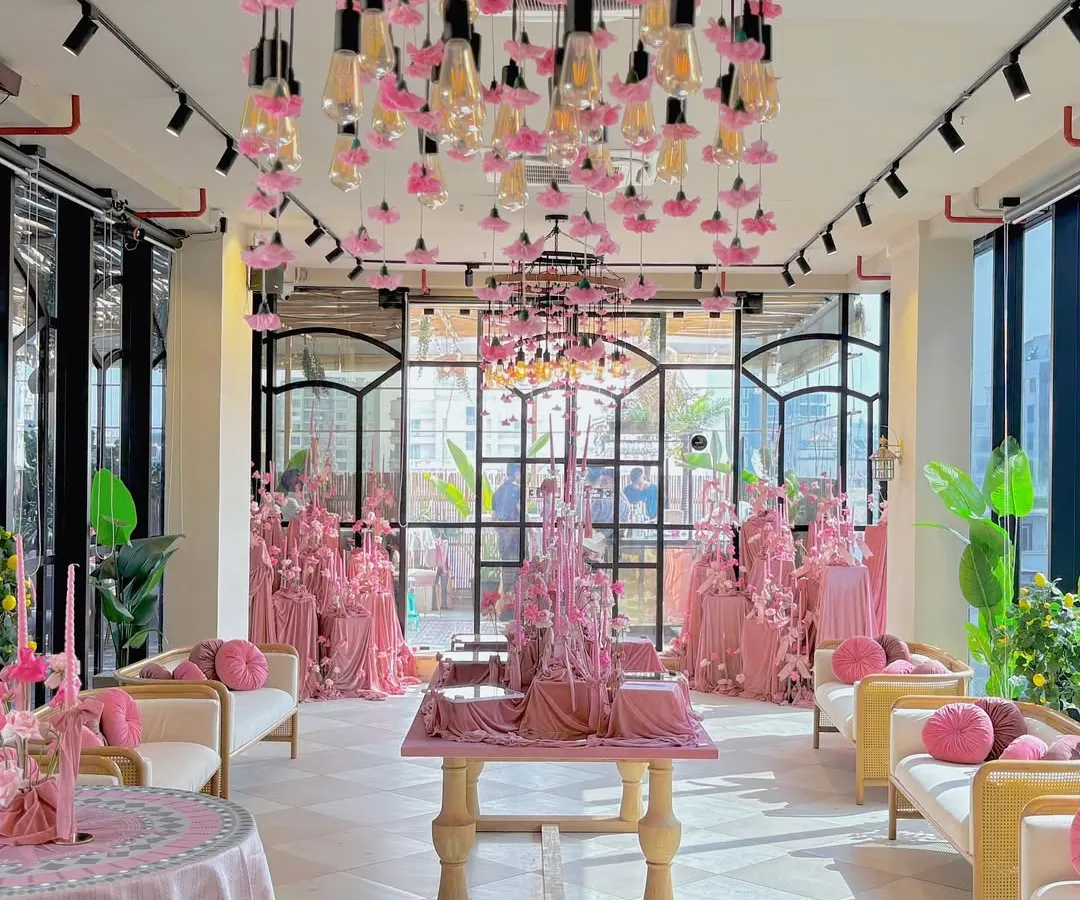 We believe in the power of a bold, monochromatic vision. This engagement party was bathed in shades of blush pink, using velvet textures, a dramatic floral chandelier, and custom lighting to create an environment of modern romance and pure elegance.