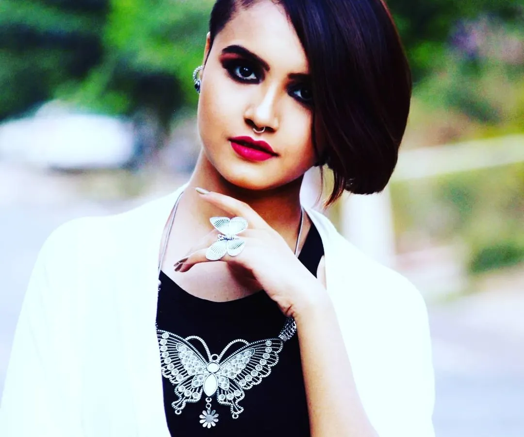 This is an example of an edgy, editorial makeup style for a fashion portfolio. I created a sharp, dark smokey eye and a classic red lip, paired with a modern asymmetrical haircut to deliver a bold and confident look.