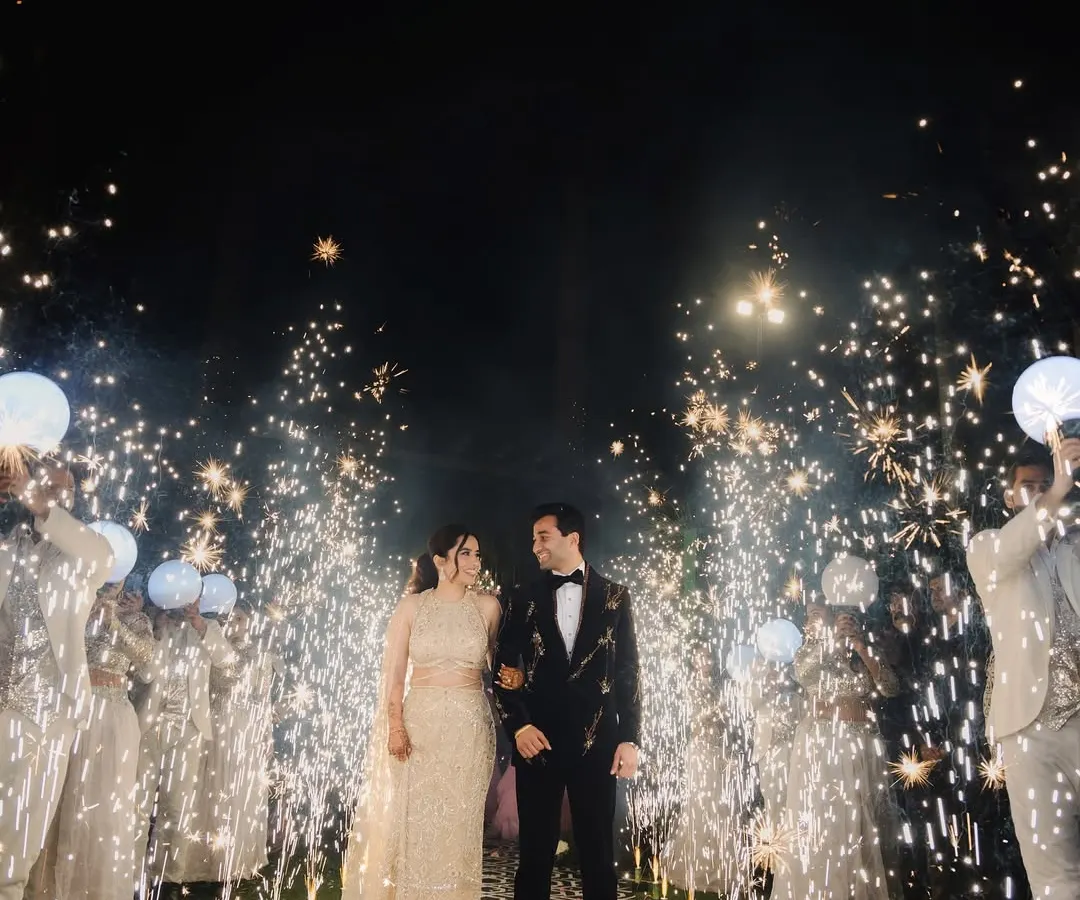 A magical sangeet night entrance, with the couple framed by a pathway of cold pyro sparklers. This shot highlights our expertise in creating dramatic, film-like moments, capturing the energy and celebration of your special evening.