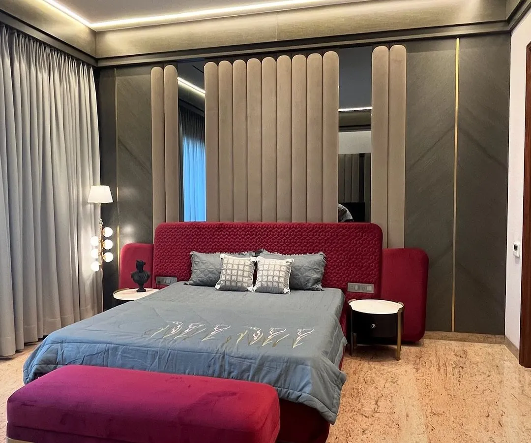 For this master bedroom in Ambala, we used a bold maroon and rich textures to create a space that feels both opulent and deeply personal. The custom upholstered wall panel behind the bed adds a layer of softness and grandeur.