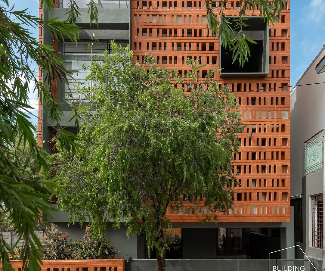 For the 'Big-Little House', we used a perforated brick screen to create a visually striking facade on a compact urban plot. This design provides privacy and ventilation while casting intricate light patterns, proving that even small footprints can have a grand architectural presence.