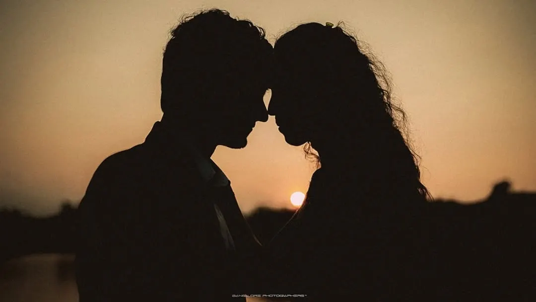 As the sun dips below the horizon, it paints the perfect silhouette of two people completely lost in their own world. This shot is all about the quiet connection, the unspoken promises, and the simple beauty of being together against a dramatic natural canvas.