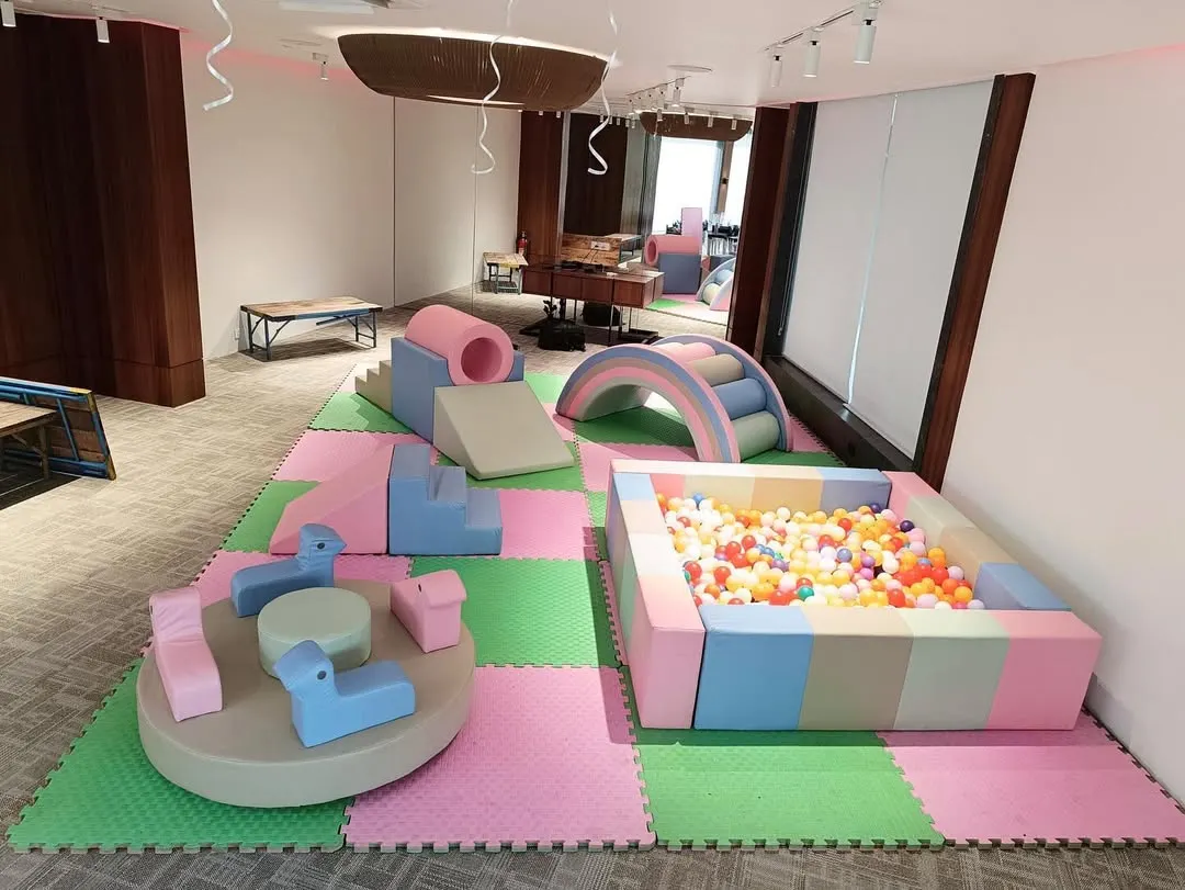Our Pastel Soft Play Area offers a gentle and modern aesthetic for any party. This setup includes a soft-walled ball pit, foam climbers and slides, a cushioned rainbow arch, and a manual carousel, all laid out on safe, interlocking floor mats.