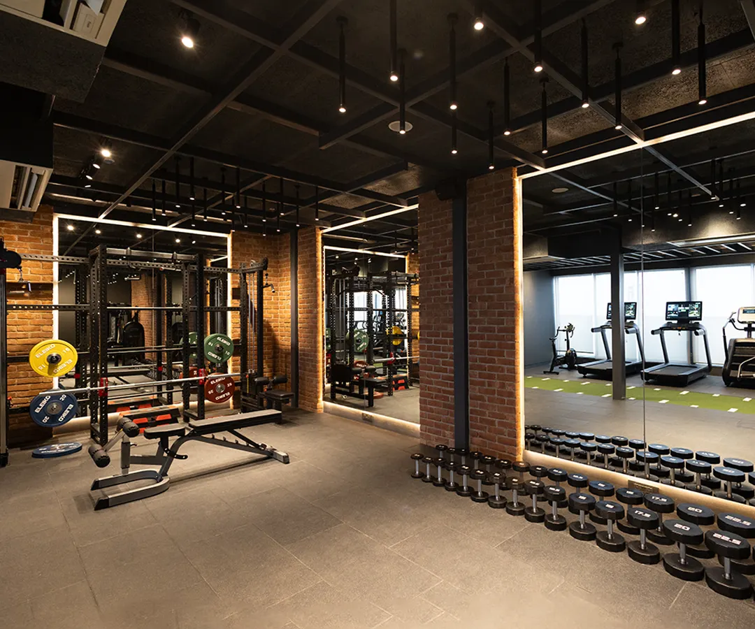 My 24-hour fitness center features a comprehensive free weights section with a full range of dumbbells and benches. The industrial chic design and spacious layout provide an motivating environment for your strength training workout.