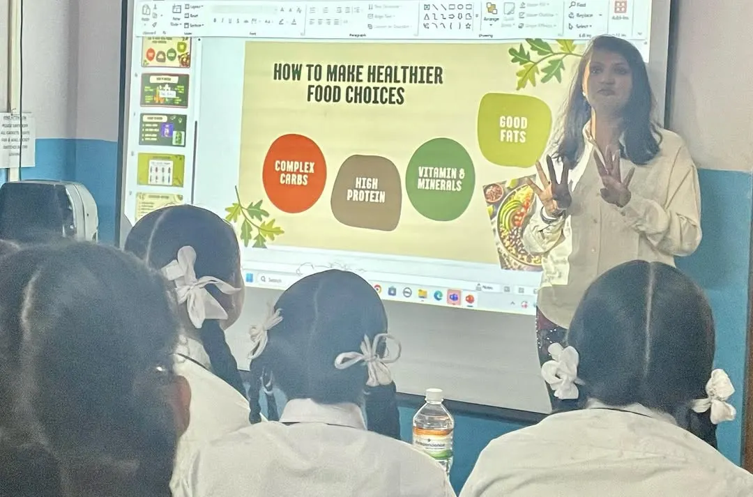 Educating the next generation on nutrition is a core part of my mission. Here, I'm explaining the fundamentals of healthy food choices to high school students, making wellness concepts accessible and relevant to their lives.