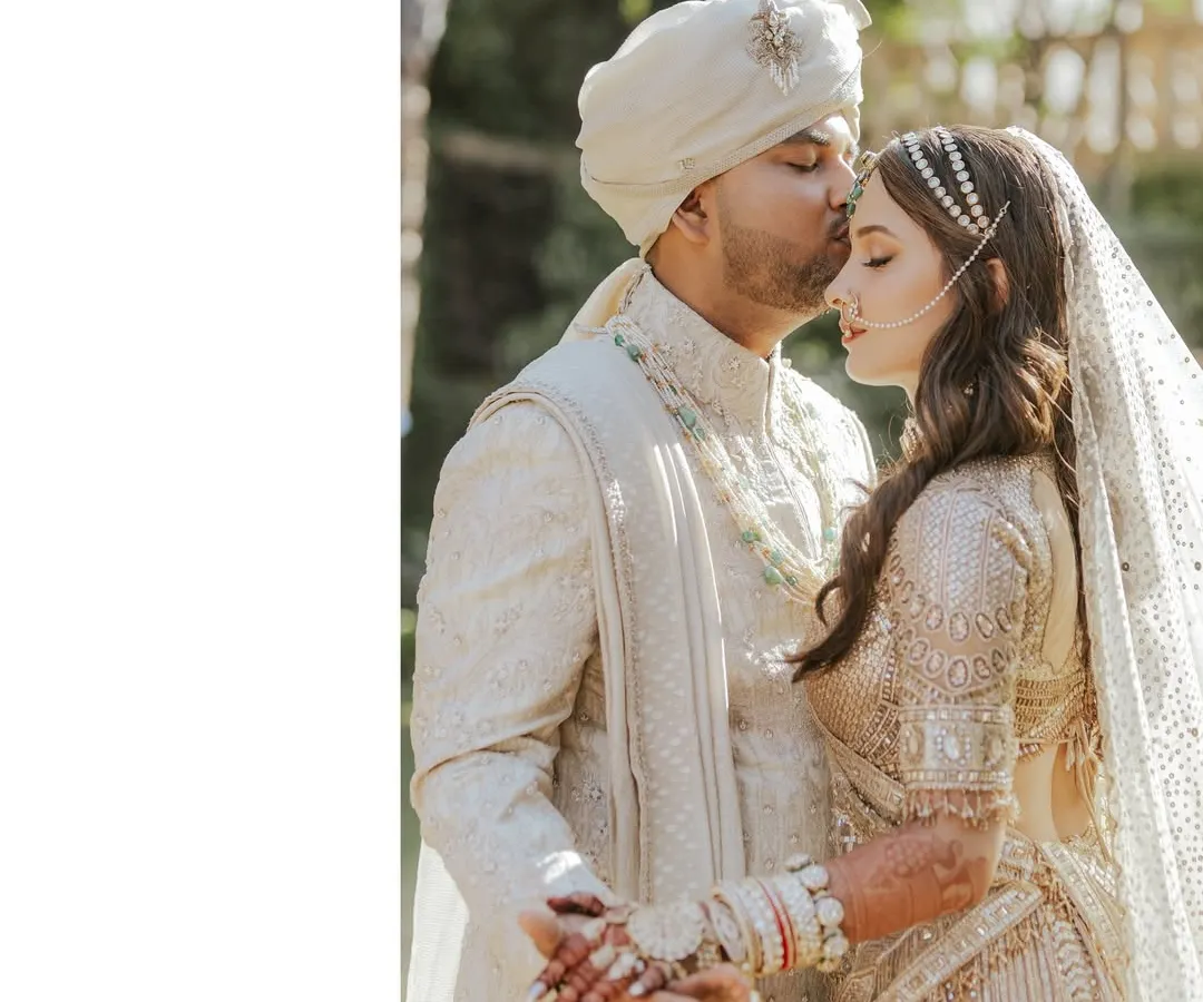That final wedding day glow. This is the moment it's all about. Here, I worked with the couple to select timeless and elegant outfits that complemented each other perfectly, focusing on intricate details like the groom's custom sherwani and the bride's delicate jewelry to complete their vision.