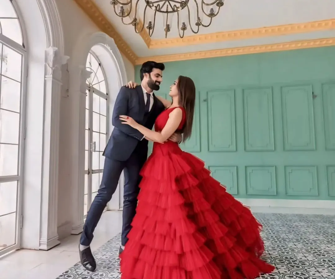 For that perfect pre-wedding shoot, I offer coordinated couple outfits. This dramatic red layered gown and complementary men's suit create a stunning visual, making your photos truly unforgettable.