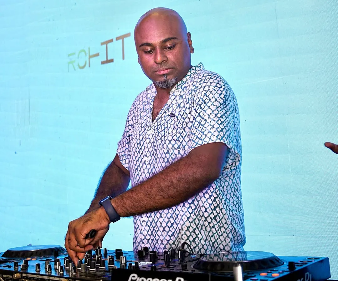 Focused behind my trusted Pioneer DJ console. For me, it's all about precision mixing and reading the crowd to play the right track at the right time, ensuring the dance floor never stops.