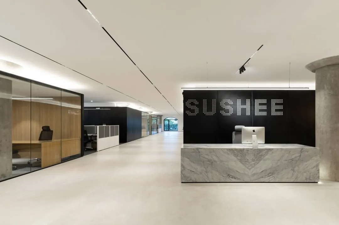 We believe workplaces must bring calm and order to our complex lives. For this high-intensity infrastructure company, we designed a reception area with a minimalist palette, featuring a monolithic marble desk and clean lines to create a serene, focused, and sophisticated environment.