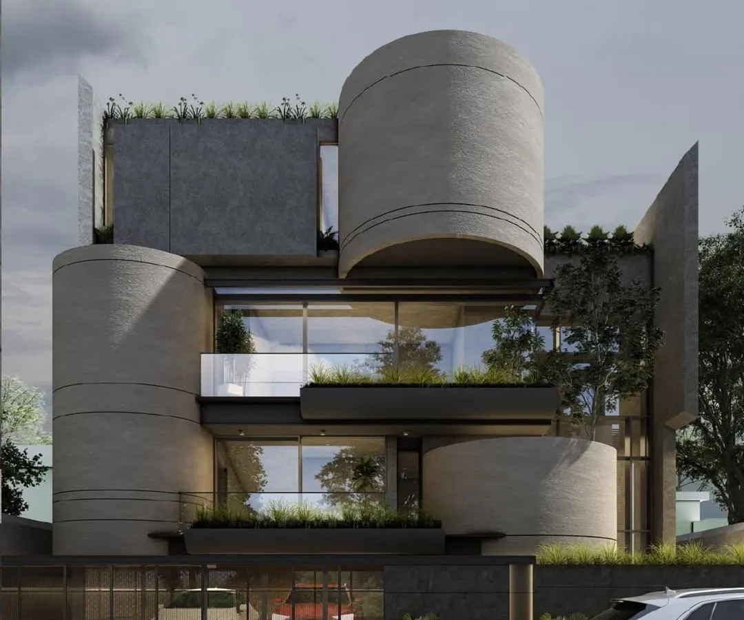 I designed this residence as a composition of bold, interlocking forms. The cylindrical concrete volumes create a powerful sculptural statement, softened by integrated planters and rooftop greenery that introduce a biophilic element to the modern facade.