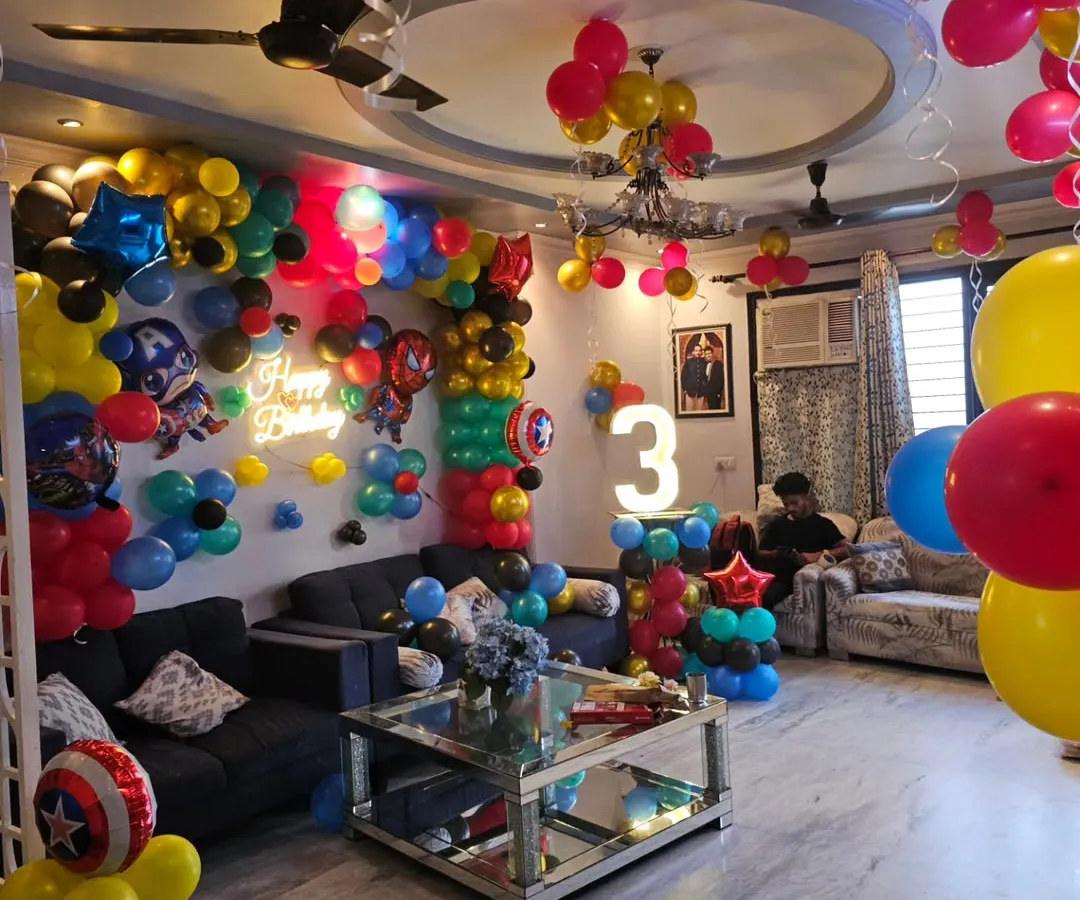 We transformed this entire living room into a Marvel superhero universe for a 3rd birthday. The setup includes a full balloon wall, character balloons, ceiling decorations, and a light-up number.