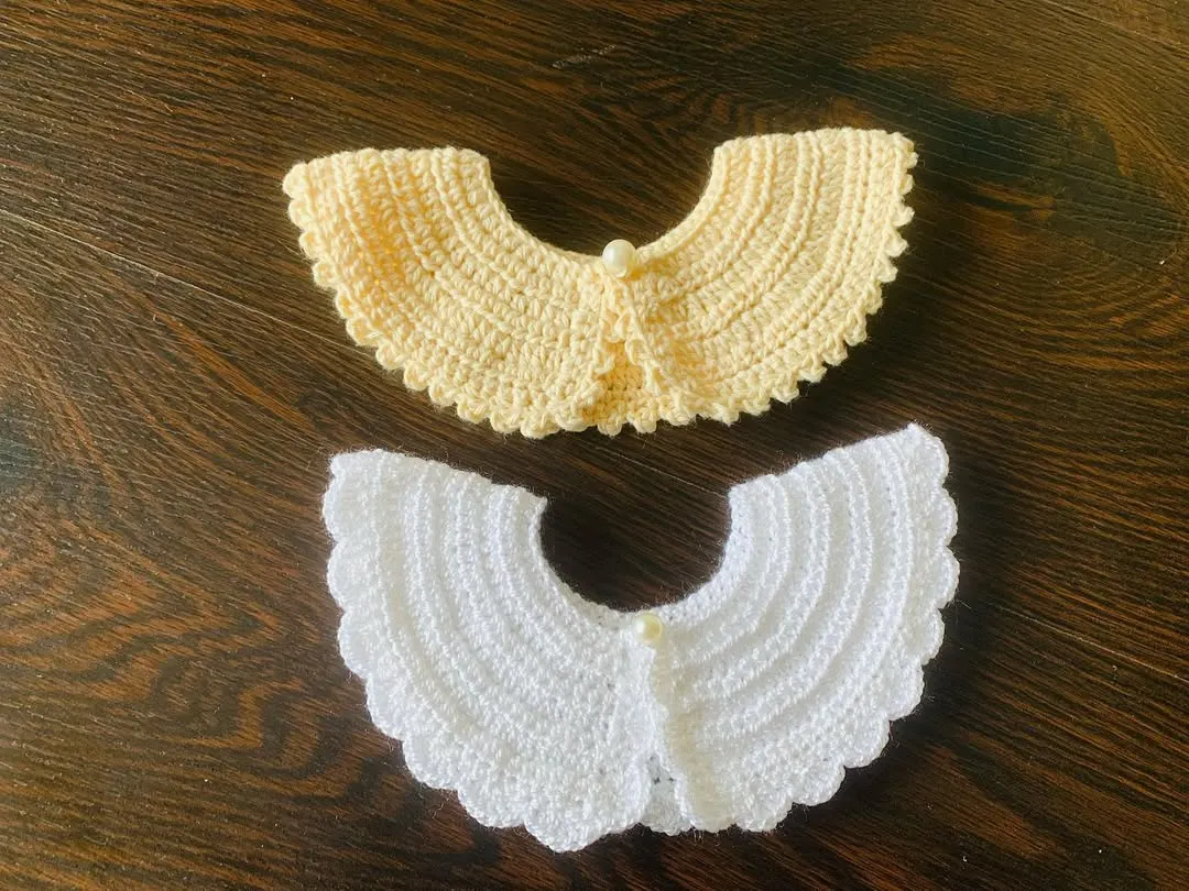 My detachable crochet collars are perfect for a quick and elegant style update. This image shows two of the available colors, white and a soft yellow, both featuring a delicate scalloped edge and a pearl button clasp. They work beautifully on both adult tops and kids' dresses.