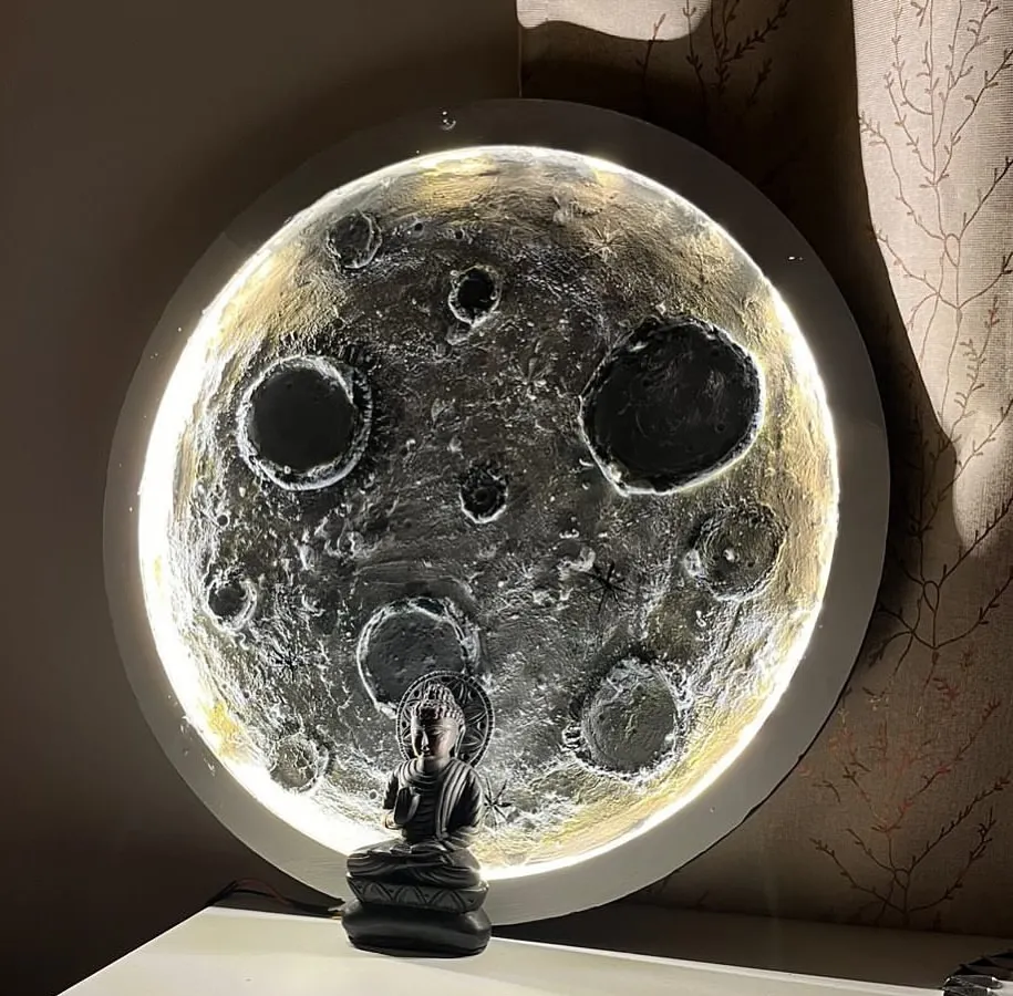 Bring the night sky into your home. Here’s a finished 3D moon lamp, created by a participant in our workshop, glowing beautifully with a small Buddha statue for a touch of serenity.