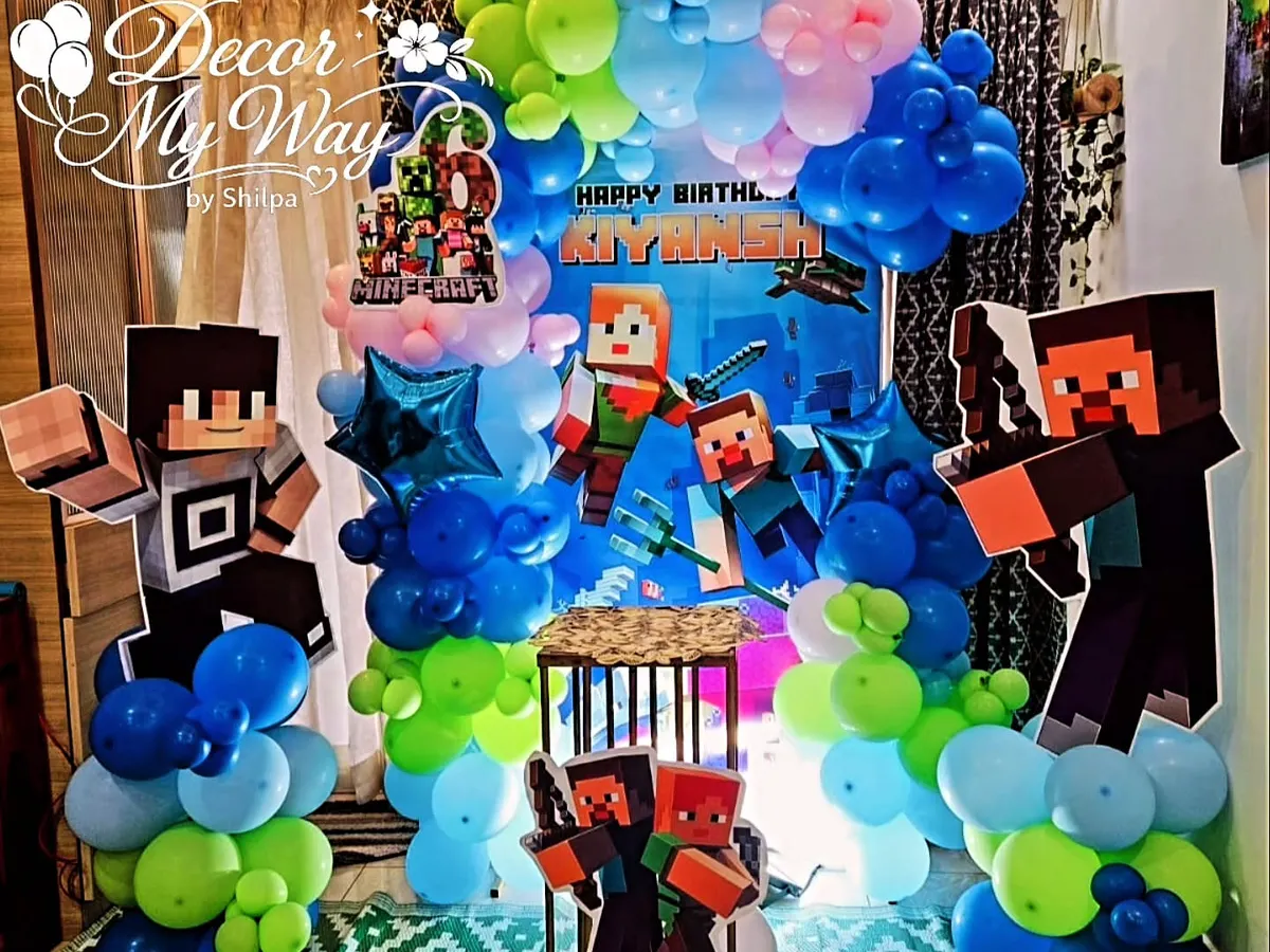 I brought the world of Minecraft to life for a 6th birthday party with this fully themed decoration. The setup includes a custom printed backdrop, character cutouts of Steve and Alex, and balloon pillars in the game's signature green, blue, and brown colors.