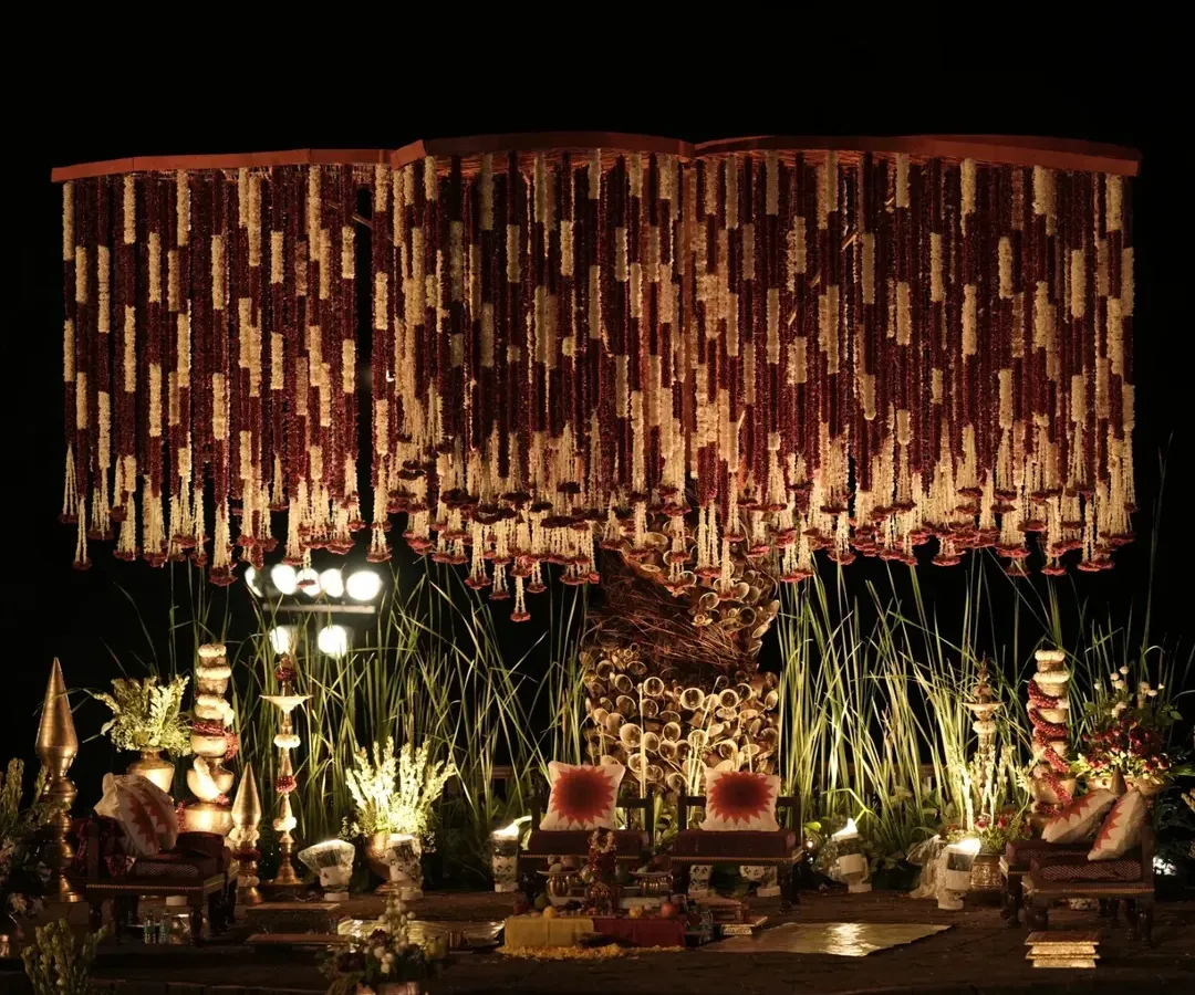 For this wedding, I brought the sacred spirit of the Banaras Ghats to life. The mandap featured a dense canopy of red and white floral strings, traditional brass bells, and an earthy, spiritual ambiance.